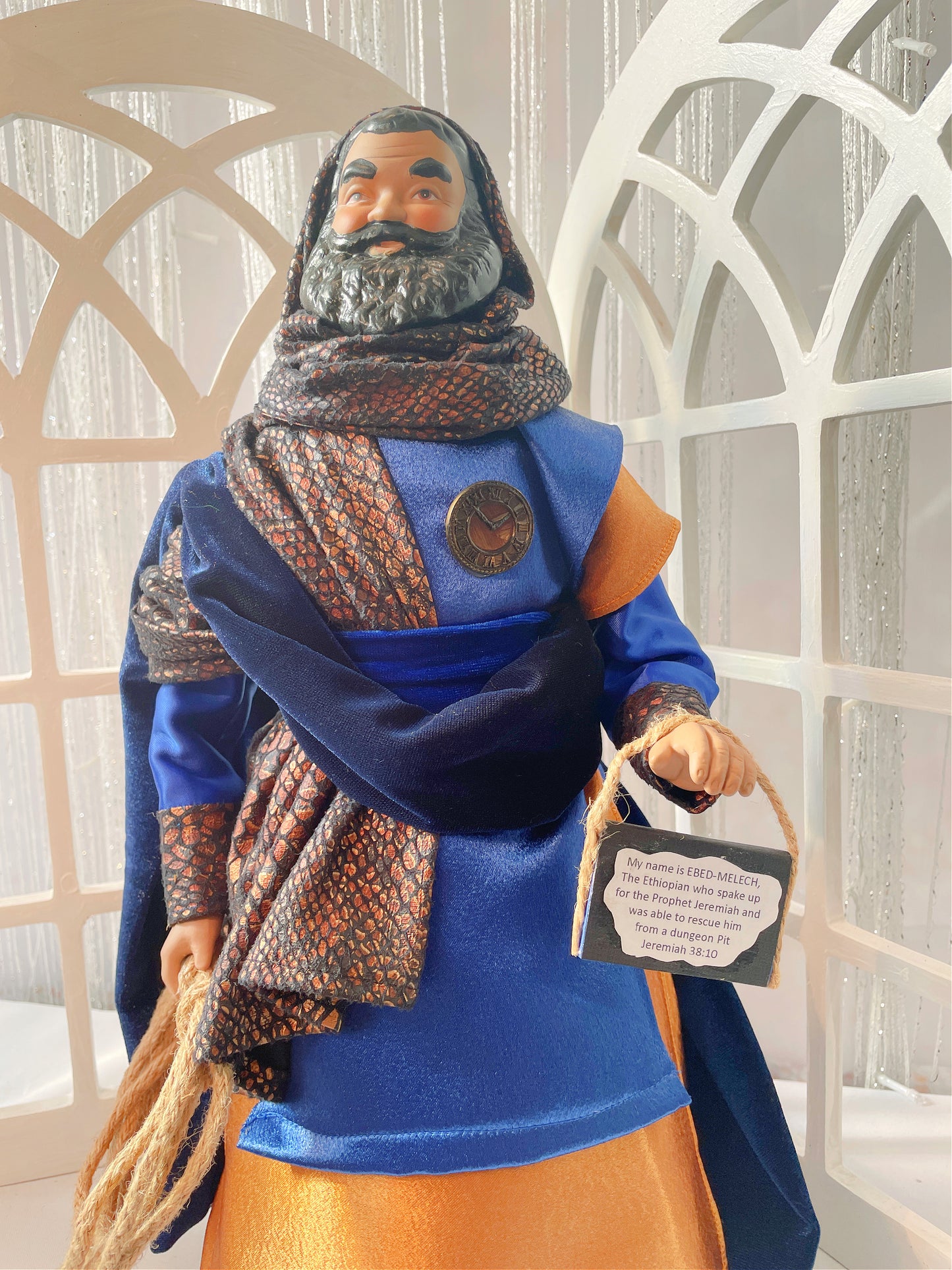 This is Ebed-Melech who saved the Prophet Jeremiah, He is wearing rust and navy blue satin and velvet because he worked in the kings house.