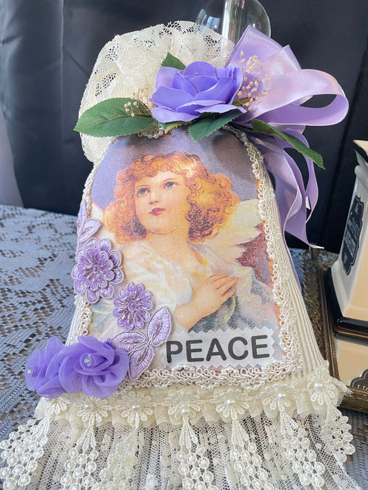Large Ivory sachet with the face of a red haired angel with purple flowers and the word peace.